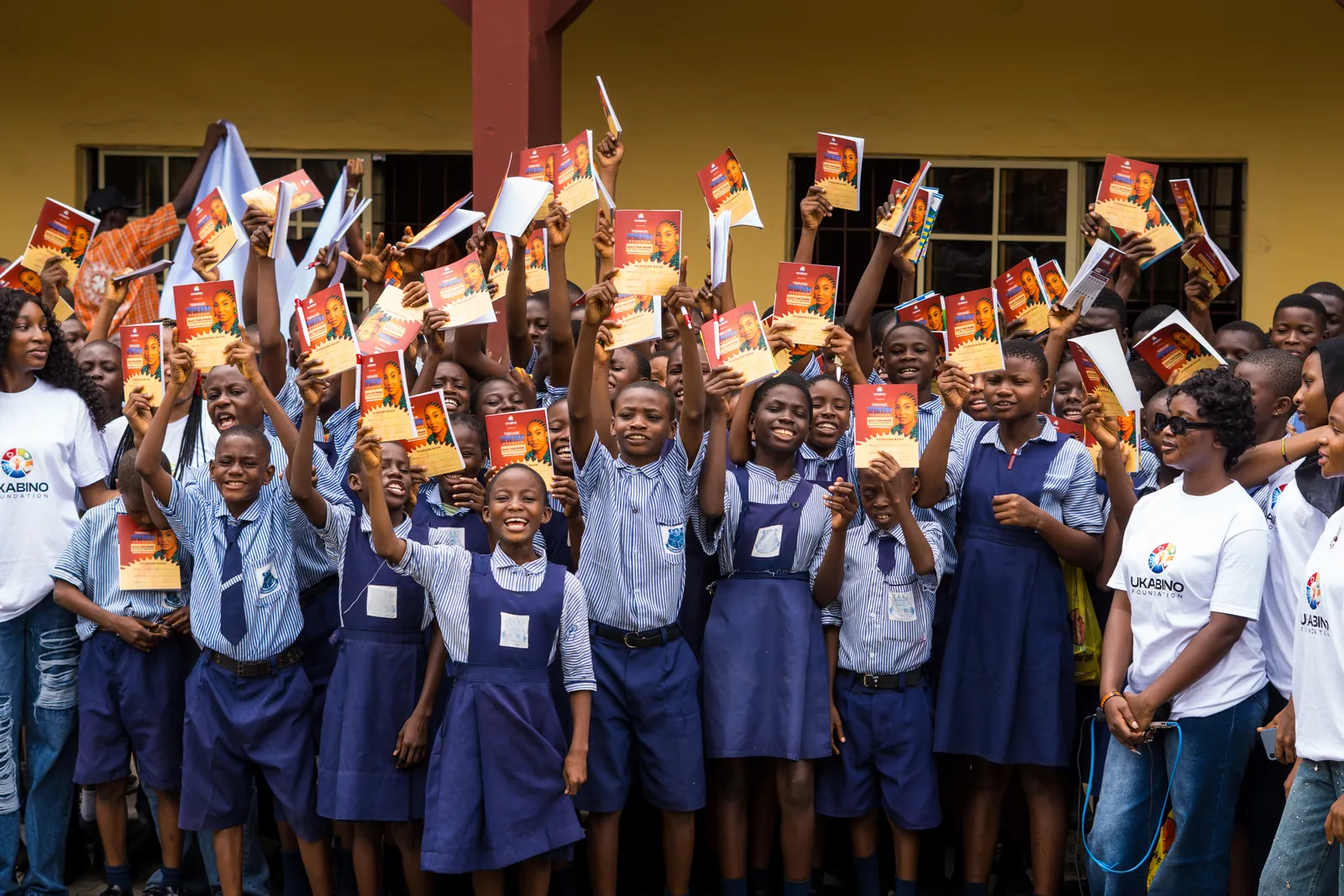 Students celebrating with books