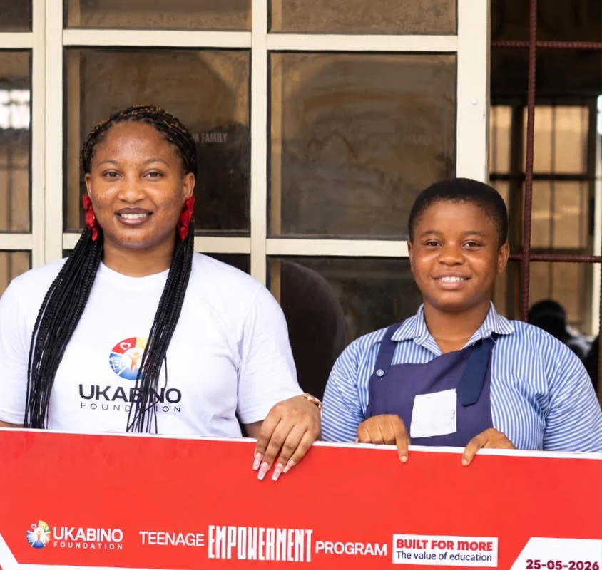 Etieno with a Ukabino Foundation representative during an education support presentation